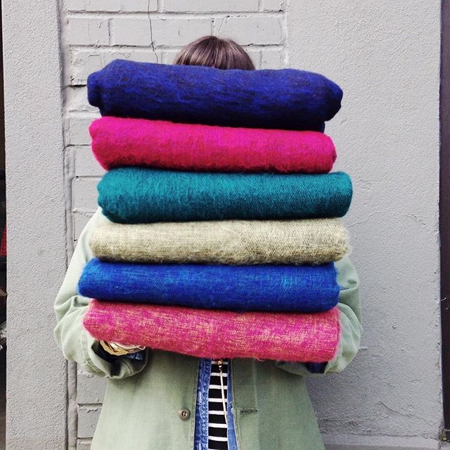 Pretty spring colors piled up high.  Cozy brushed wool blankets perfect for every season.